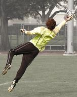 goalkeeper catches the ball in a jump, monochrome