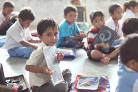 children holding drawings at school in india