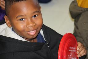 photo of african boy with frisbee