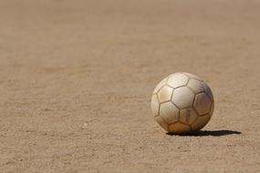 weathered white Ball on ground