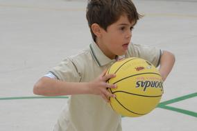 Sport in school, Child boy with basketball