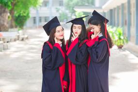 three asian college graduates