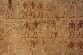 antique paintings on the walls of buildings in Egypt