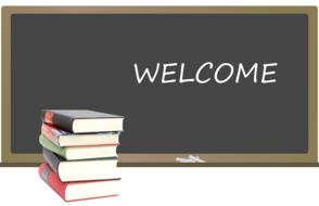 welcome, writing on black board, and stack of books