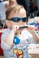 baby in sunglasses and harmonica