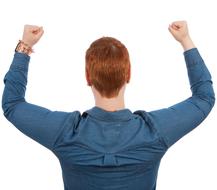 Winner, back view of redhead woman, hands up