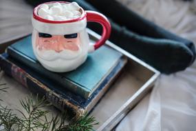 christmas cup stands on old books