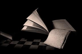 open book and lecture notes in darkness