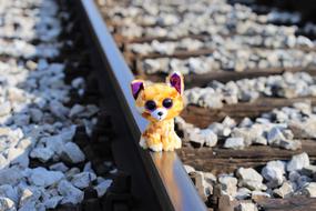 soft toy cat on railway