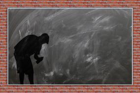 black silhouette with sprayer on school chalkboard
