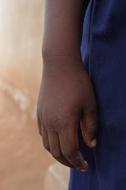 Hand of African child boy at side