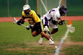 photo of lacrosse players in helmets on the field at competitions