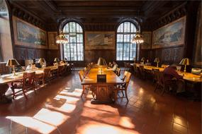 people reading in historical interior of library