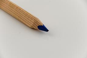 photo of a blue pencil on a white table