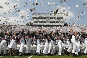officers throw caps on graduation