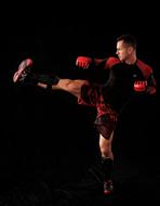 Man training Wing Tzun at dark background