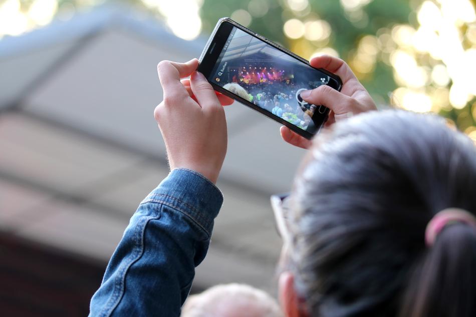 Phone taking photo of Music Festival