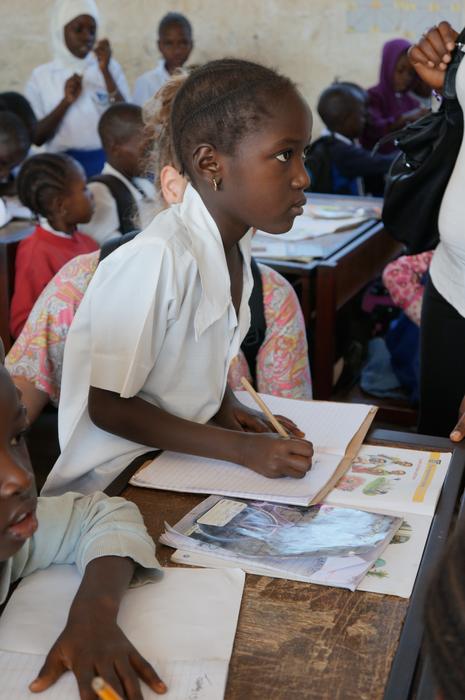 Profile portrait of the schoolgirl among the other people