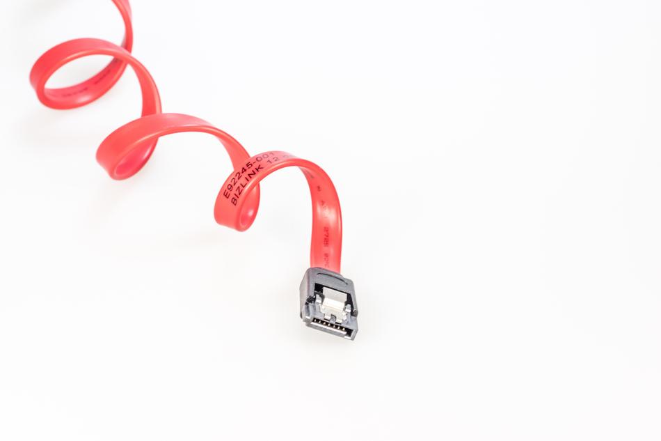 Shiny, pink SATA cable, at white background