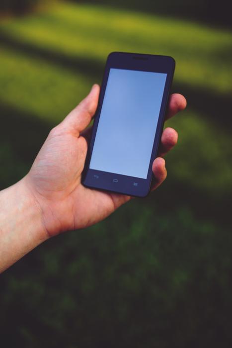 smartphone in hand outdoors