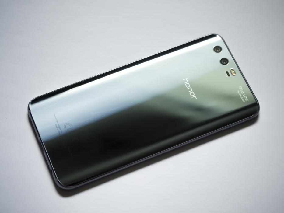Shiny 'Honor 9' smartphone, laying upside down on the white surface