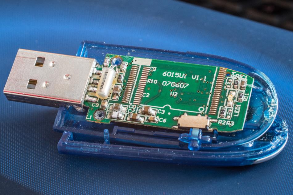 Close-up of the colorful USB stick with details, on the blue surface