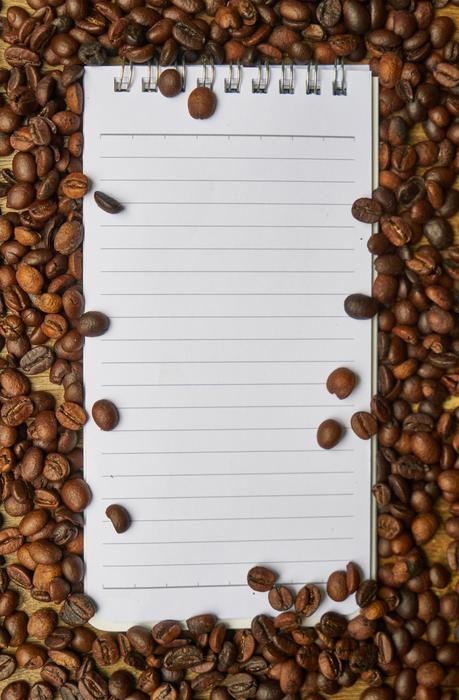 notebook with clean sheets on coffee beans