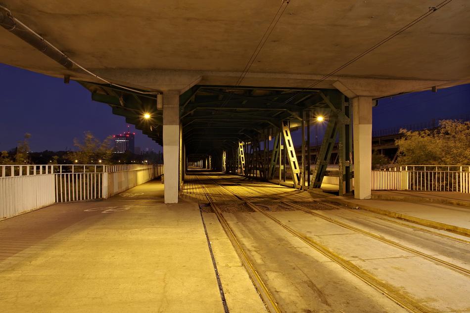tramway rails under the bridge at night
