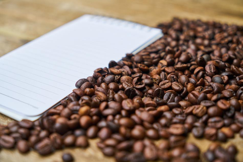blank notepad near coffee beans