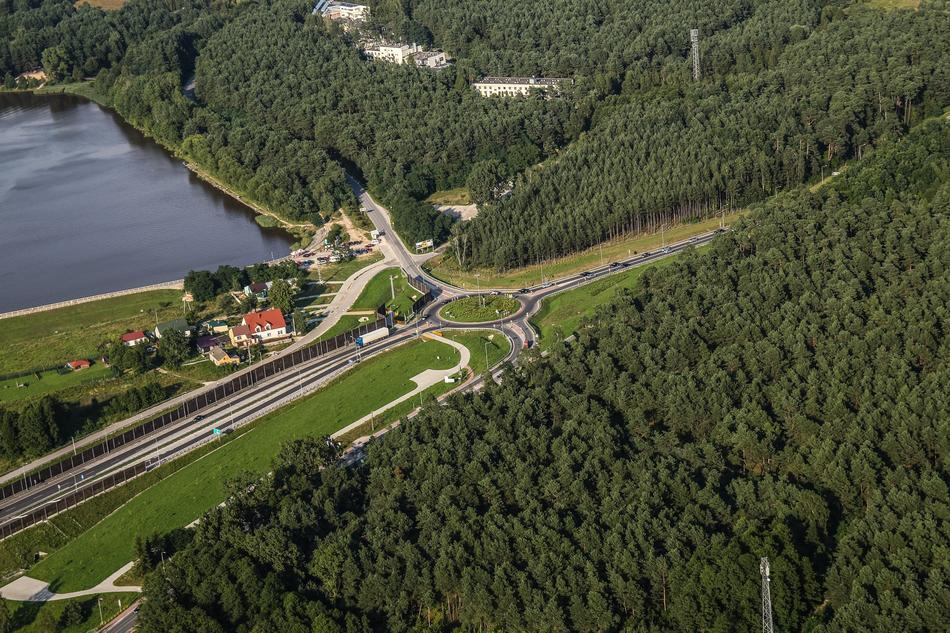 aerial view of transport hub on waterside near forest