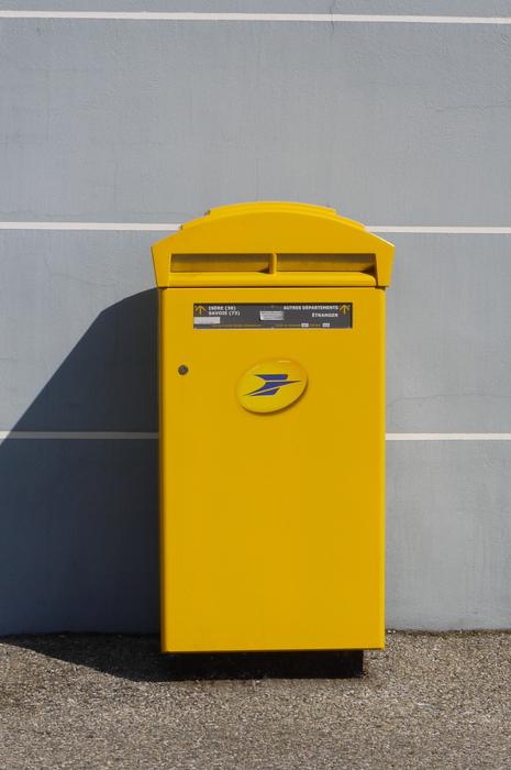 yellow mailbox near the wall