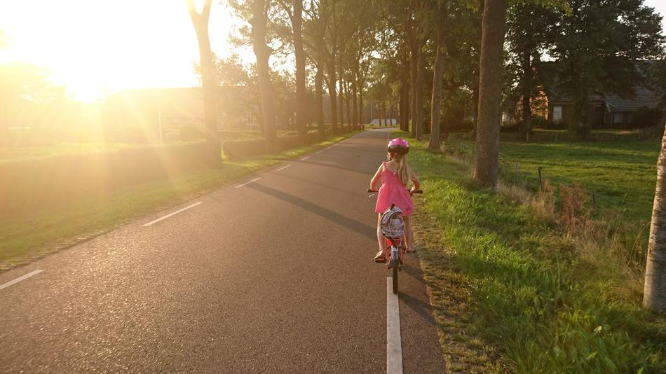 Girl Riding Bicycle sun