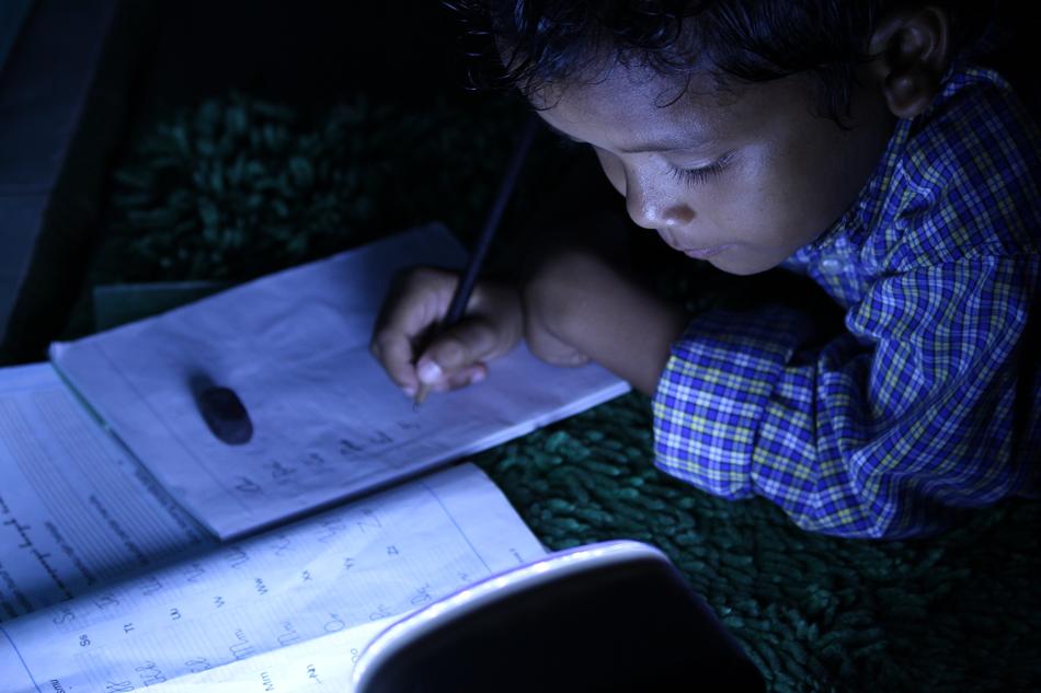 portrait of child studying in the dark