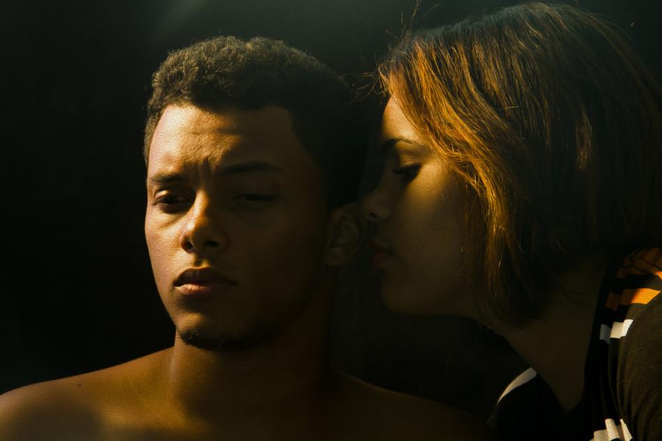 girl whispers a secret in boyfriendâs ear