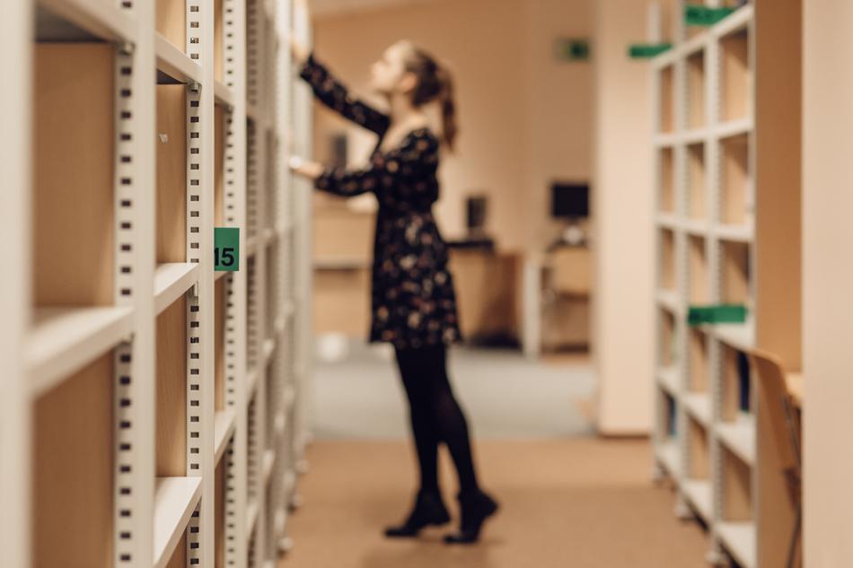 young girl at bookshelves, Blurred image