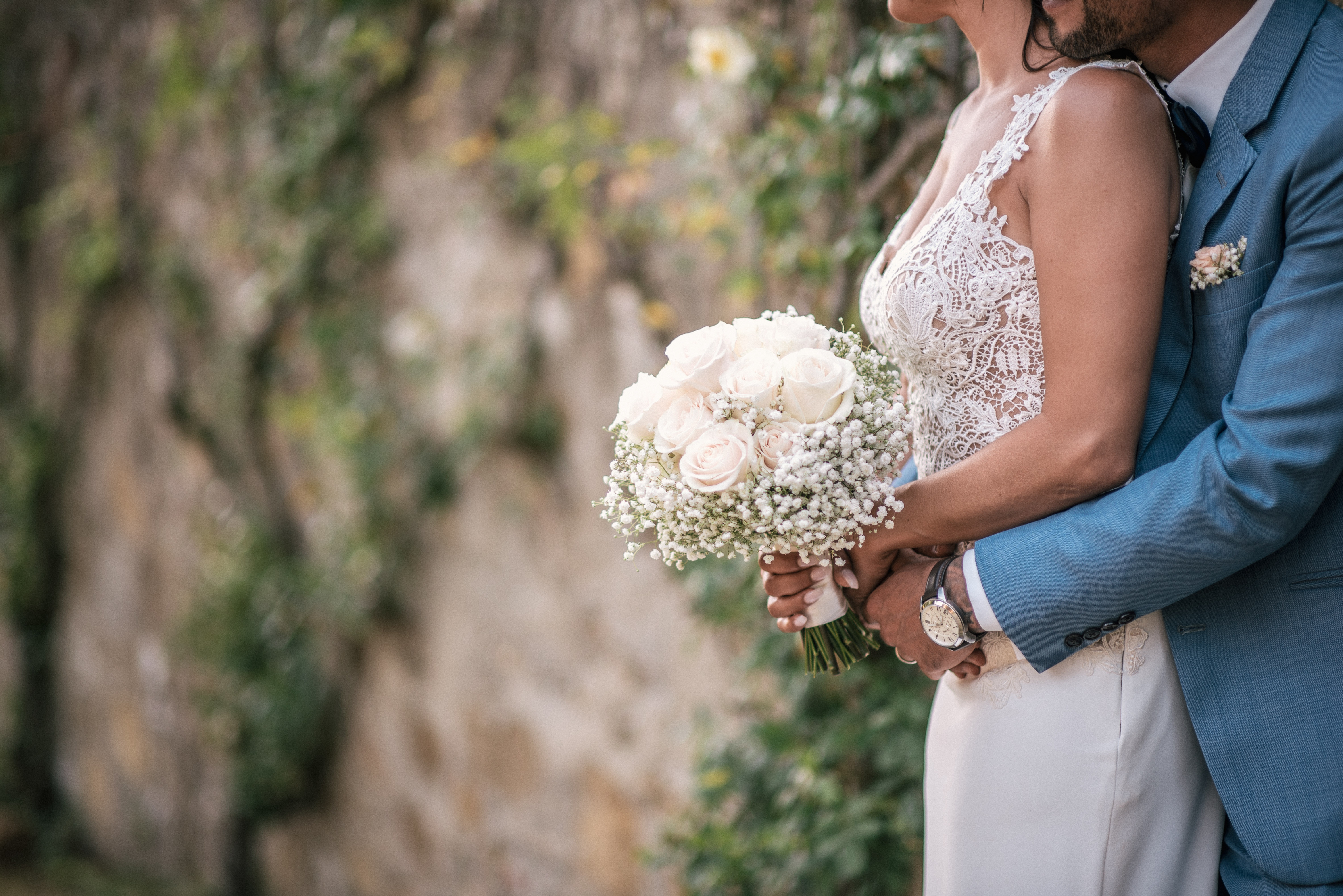 Newlyweds with a bouquet on a blurred background free image download