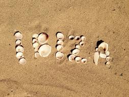 Ibiza, seashell word on sand