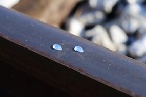 Close-up of the frozen tears on railways, among the rocks, in light