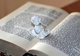 Angel figurine on open book