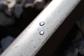 Frozen tears on a railway, with light reflections