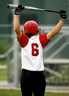 girl in uniform at number 6 in softball