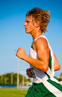 young runner in white-green uniform