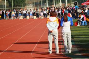 University students on the court, with the fence