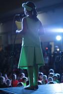 child with a book on stage