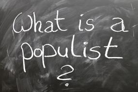 White "populist" chalk sign with the question, on a blackboard