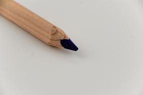 Wooden black pencil on a white table