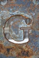 Letter G on a rusty background