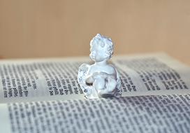 baby Angel figurine on open book