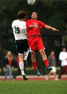 Soccer player, jumping, while playing, on the stadium