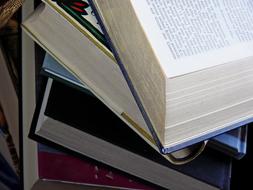 Stack of the colorful books with open page